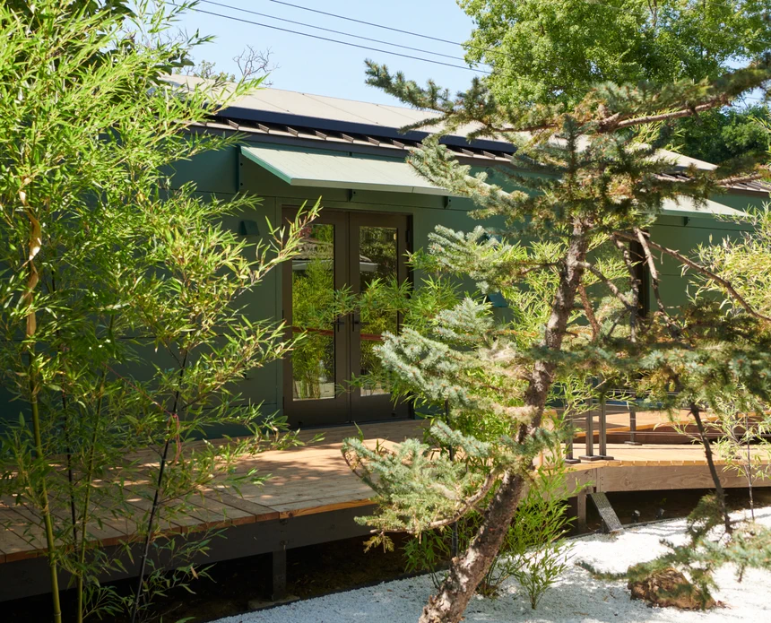 The tranquil yard includes fruit-bearing and maple trees, plenty of bamboo, and a zen-like rock garden.